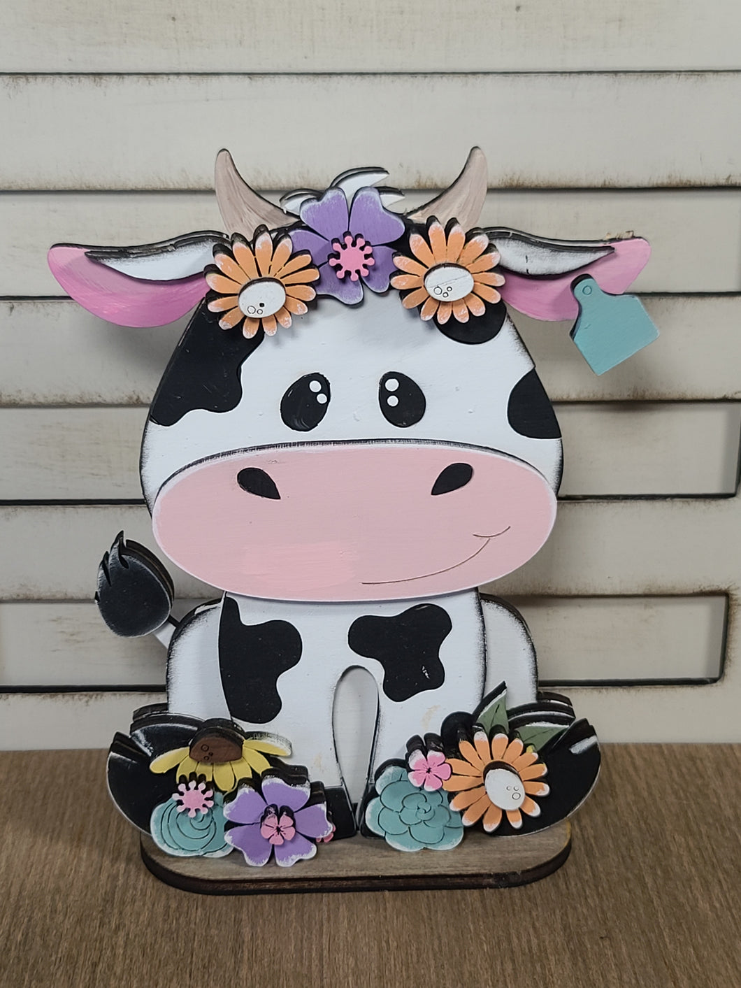 Spotted dairy cow with flowers